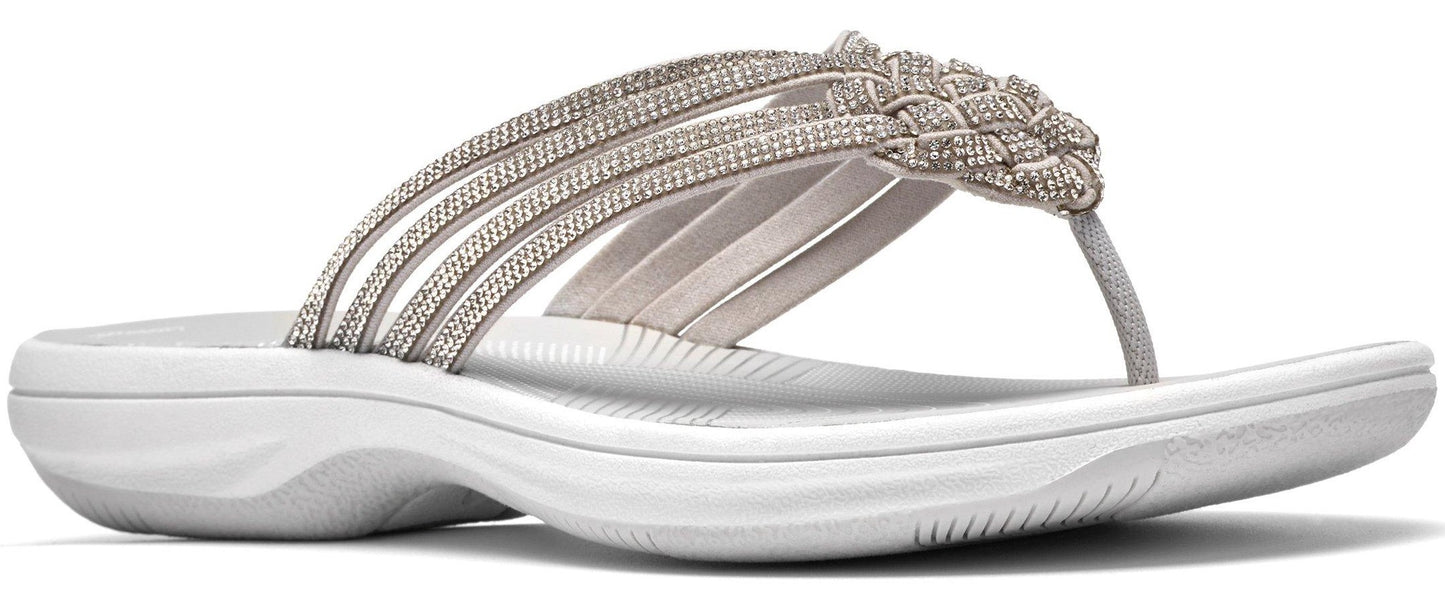 A white sandal with a woven strap.