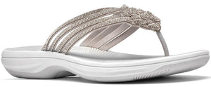 A white sandal with a woven strap.