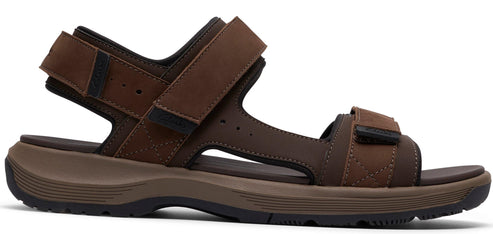 A brown sandal with velcro straps.