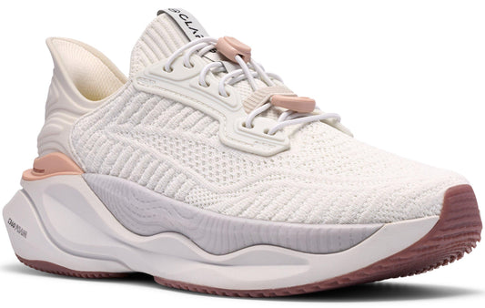 A white sneaker with a pink sole and trim, featuring a knit upper and a wavy midsole.