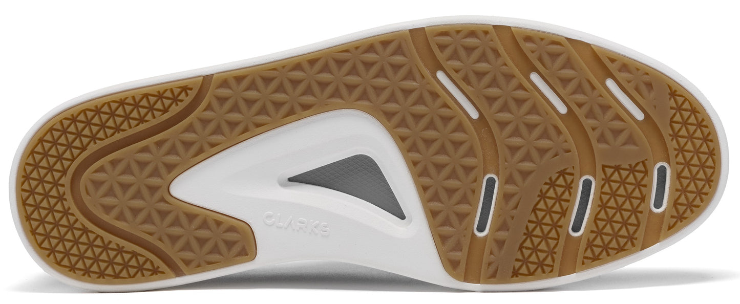 A close-up of the rubberized outsole of a shoe, featuring a brown geometric tread pattern with a white central area and a small triangular grey insert, showing the word 'CLARKS' embossed in the center.