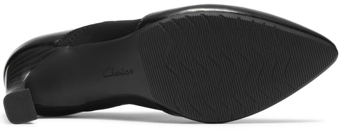 The underside of a black women's dress shoe, showing a textured, grooved sole, a block heel, and the word Clarks embossed on the arch.