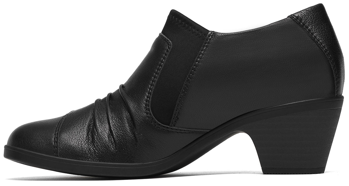A black leather slip-on ankle boot with a rounded toe, subtle pleating on the side, elastic side gussets, and a low, block heel.