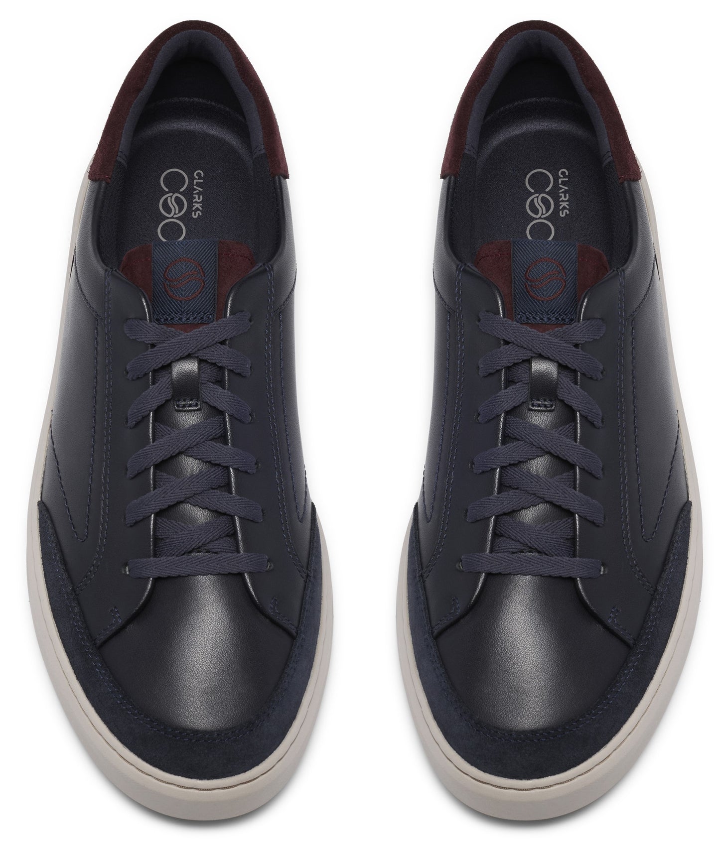 A pair of navy blue leather sneakers viewed from directly above, featuring matching navy laces, a white rubber sole, and a dark burgundy accent on the heel collar.