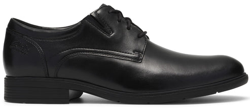 A black leather men's dress shoe with a round toe, lace-up closure, low heel, and minimalist stitching details on the side.