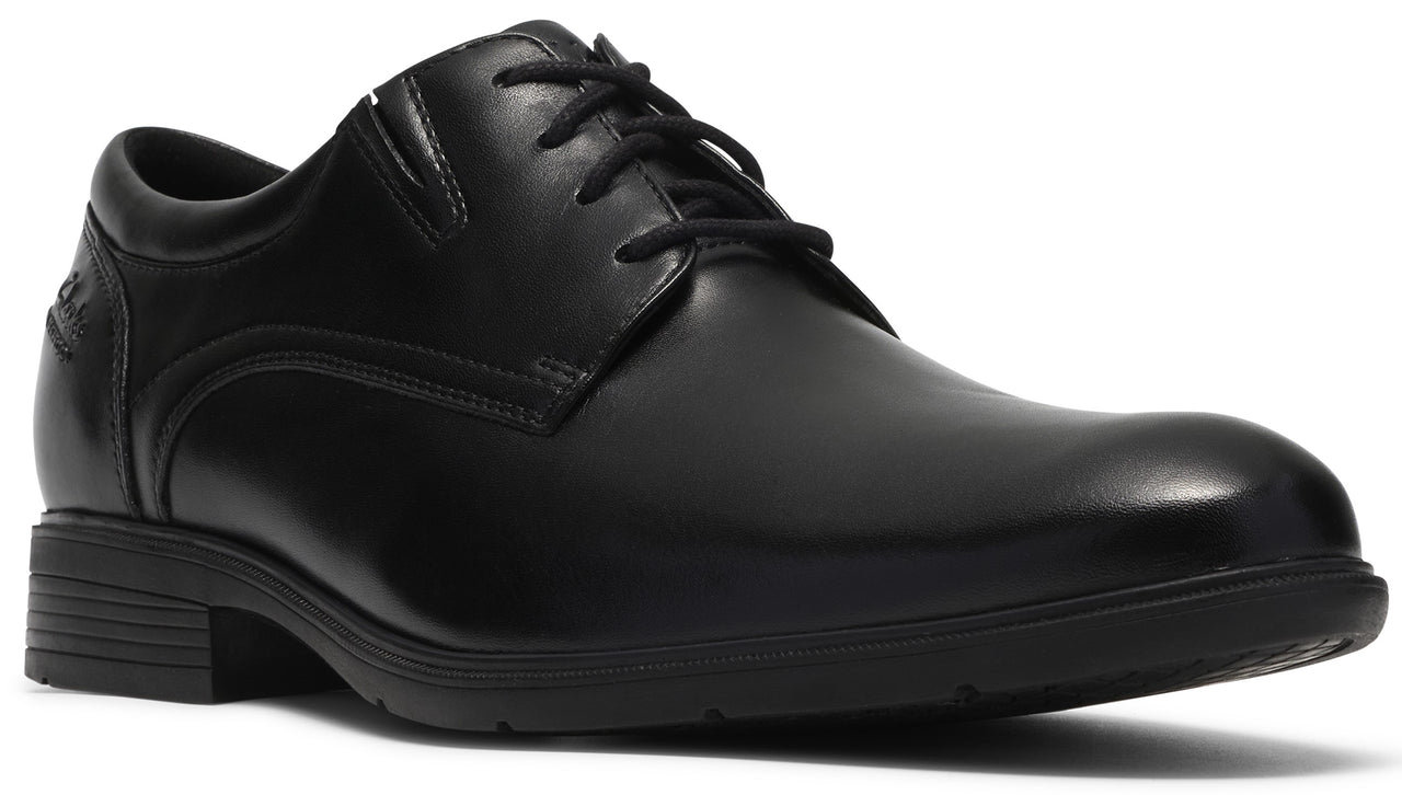 A black leather dress shoe with a rounded toe, a lace-up front, and a low, textured rubber sole.