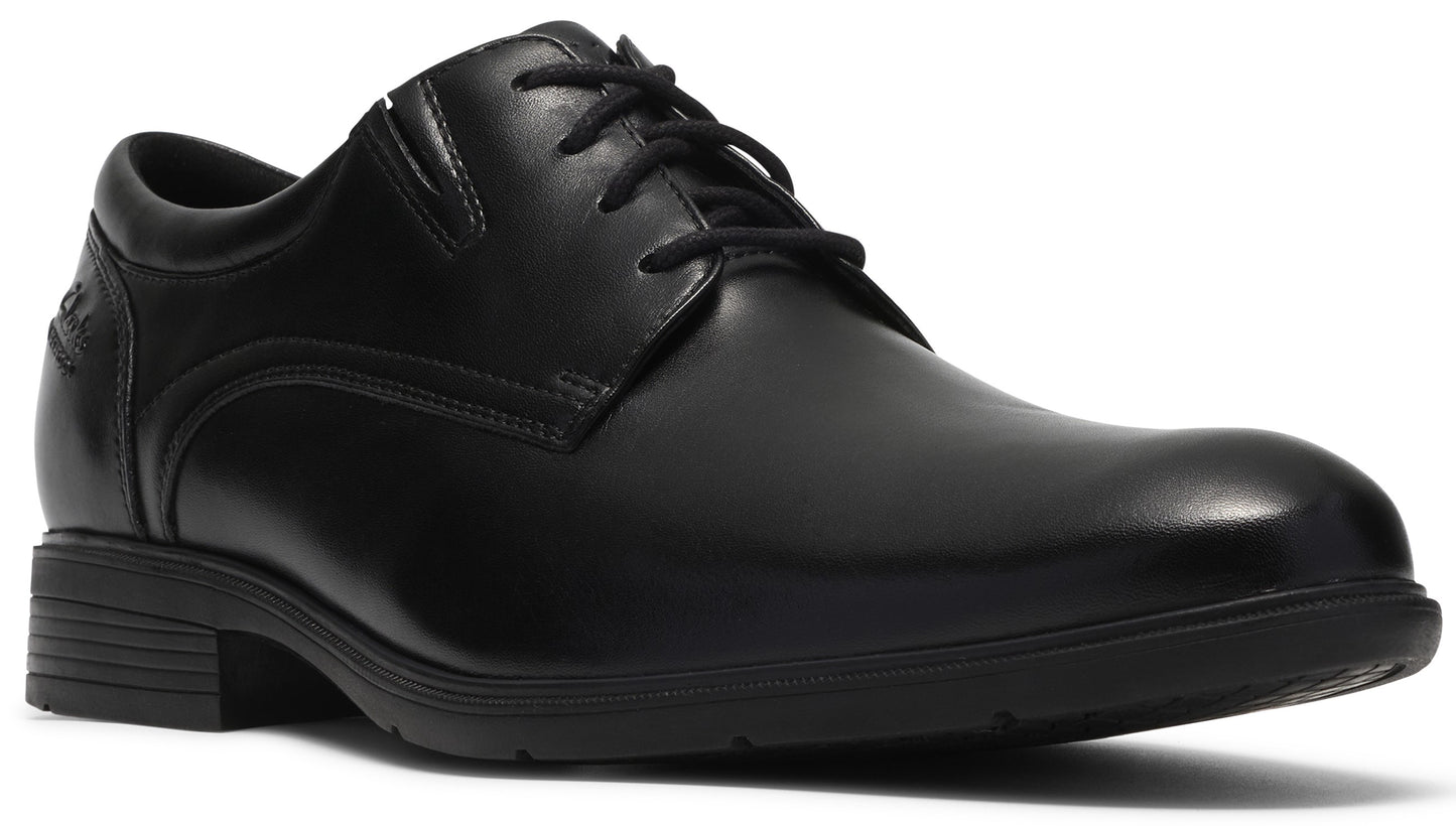 A black leather dress shoe with a rounded toe, a lace-up front, and a low, textured rubber sole.