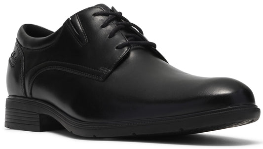A black leather dress shoe with a rounded toe, a lace-up front, and a low, textured rubber sole.