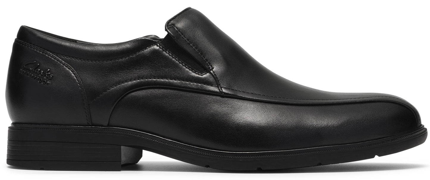 A black leather slip-on dress shoe with a classic moc toe design, a small embossed logo on the outer heel, and a solid black rubber sole.