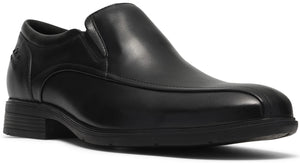 A black leather slip-on dress shoe with a moccasin-style toe seam, low heel, and a thick black sole.