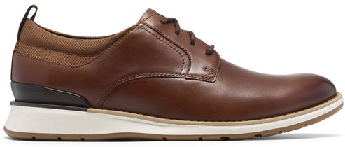 A brown leather lace-up shoe with a white rubber sole, tan fabric accents around the collar, and a dark brown heel insert.