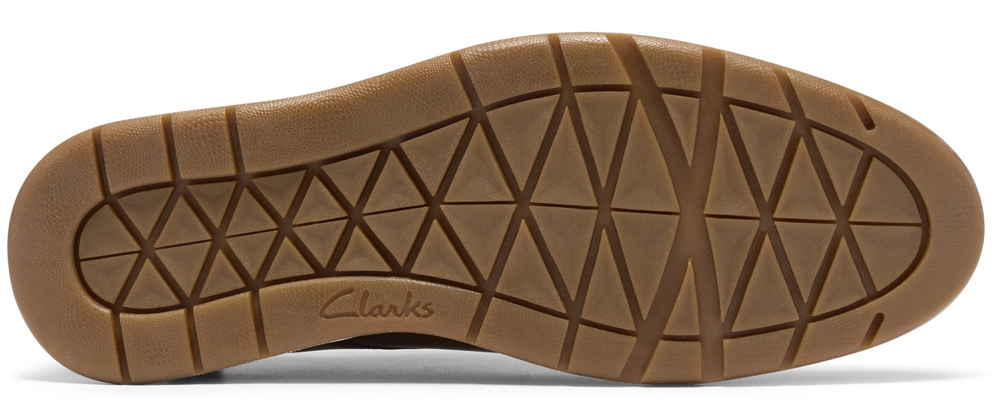 A brown rubber shoe outsole with a triangular geometric tread pattern and the brand name Clarks embossed in the center.