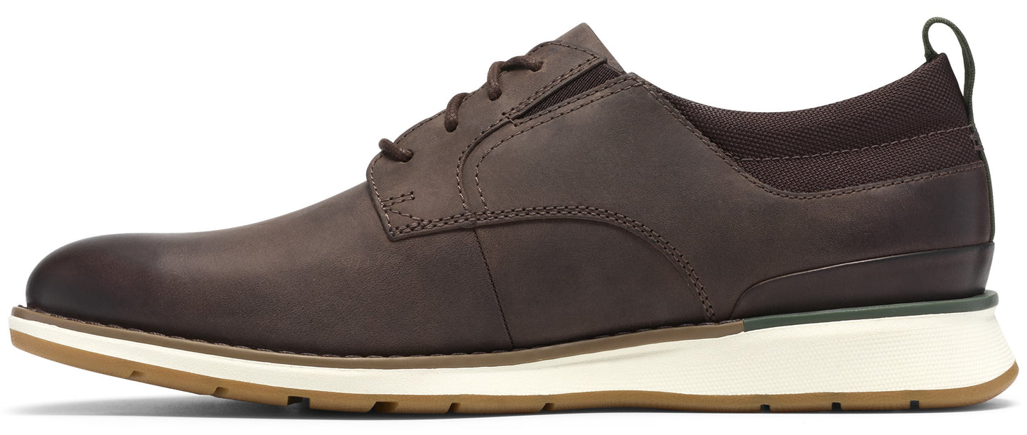 A brown leather lace-up shoe with a white midsole and a light brown rubber outsole, shown from a side profile.