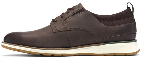 A brown leather lace-up shoe with a white midsole and a light brown rubber outsole, shown from a side profile.