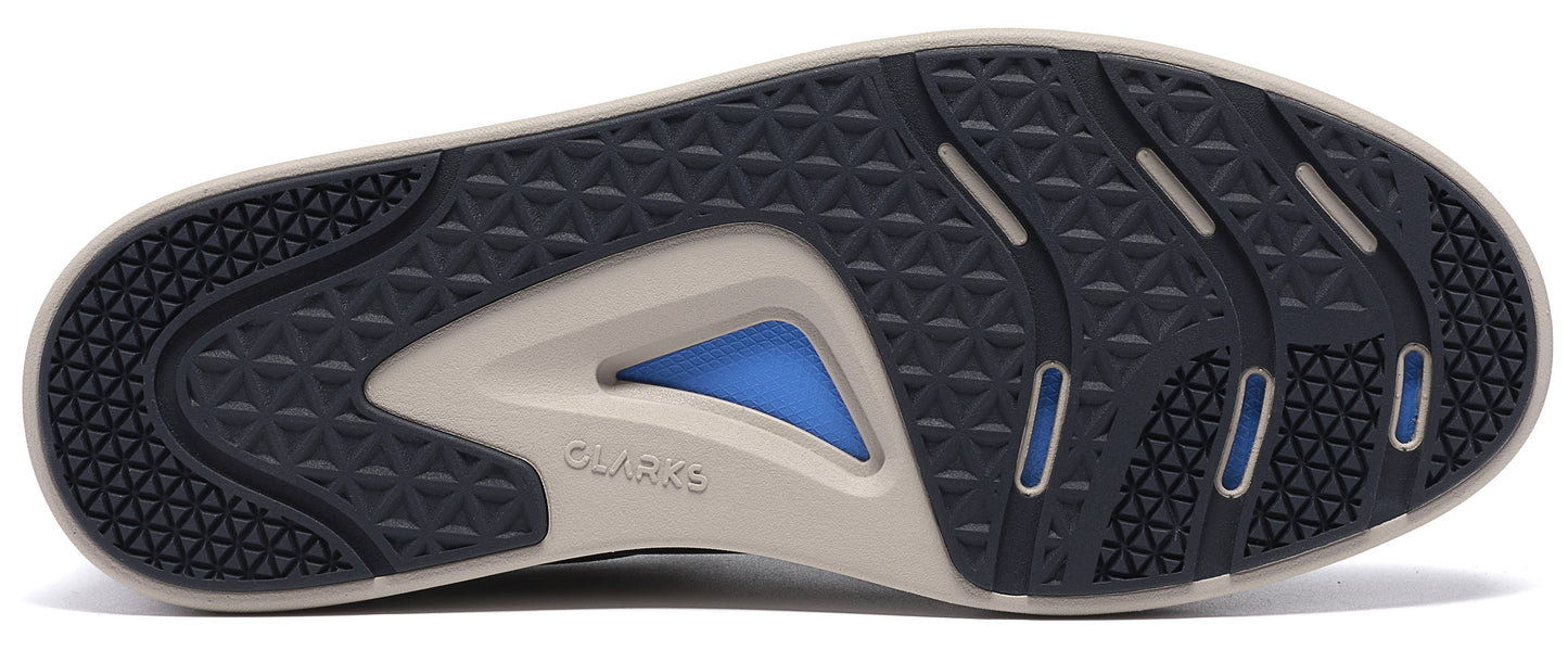 A bottom view of a shoe sole showing a dark blue tread pattern with geometric detailing and a light beige frame, featuring a triangular blue insert in the middle and the text 'CLARKS' embossed on the side.