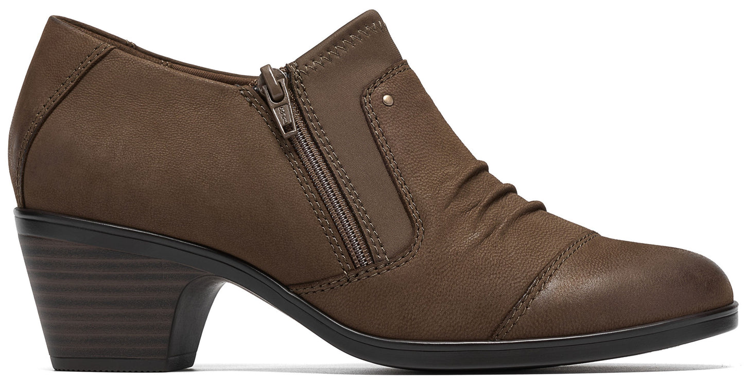 A brown, ankle-height bootie with a low, stacked heel and a side zipper closure, featuring a textured upper with ruched detailing near the toe.