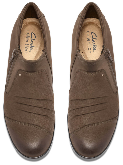 A pair of brown women's ankle boots with a side zipper and textured leather toe, shown from a top-down view.