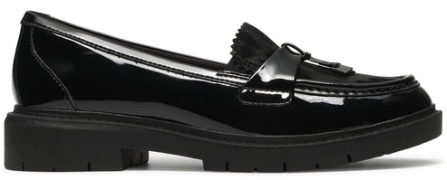 A black patent leather loafer shoe featuring a chunky lugged sole, a kiltie fringe detail, and a strap across the vamp.