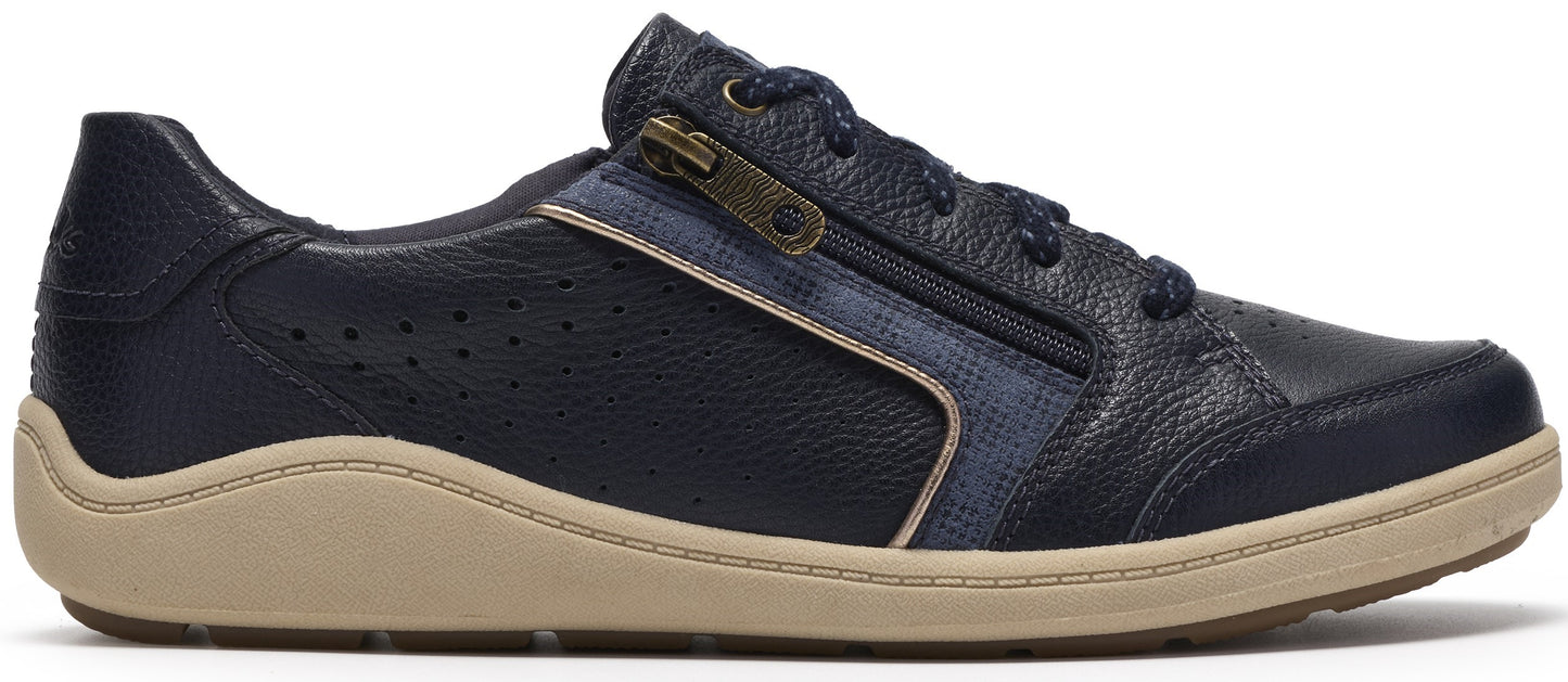 A navy blue leather sneaker with a side zipper, featuring perforated side panels, navy blue laces, and a thick, wavy-edged tan rubber sole.