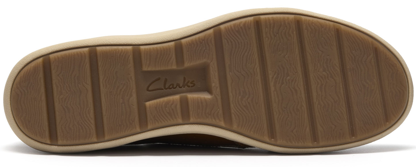 A tan shoe sole with a textured surface and horizontal grooves, featuring the text 'Clarks' embossed in the center.
