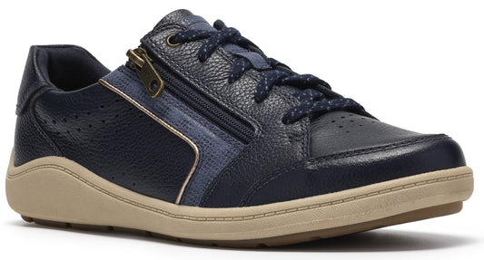 A navy blue leather sneaker with a side zipper, dark blue patterned laces, and a thick tan rubber sole.