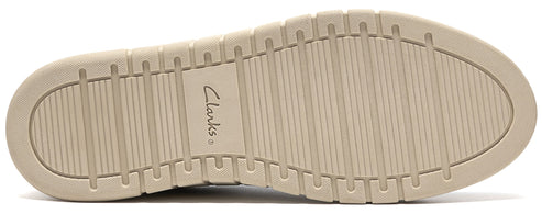 A beige rubber shoe sole with a horizontal ribbed tread pattern and the word Clarks embossed in the center.