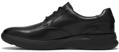 A sleek, black leather oxford shoe with a low profile, black rubber sneaker-style sole, viewed from the side.