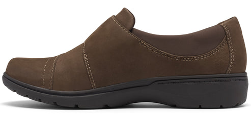 A brown, slip-on comfort shoe with contrast stitching, a rounded toe, and a dark brown, flexible, textured rubber outsole.