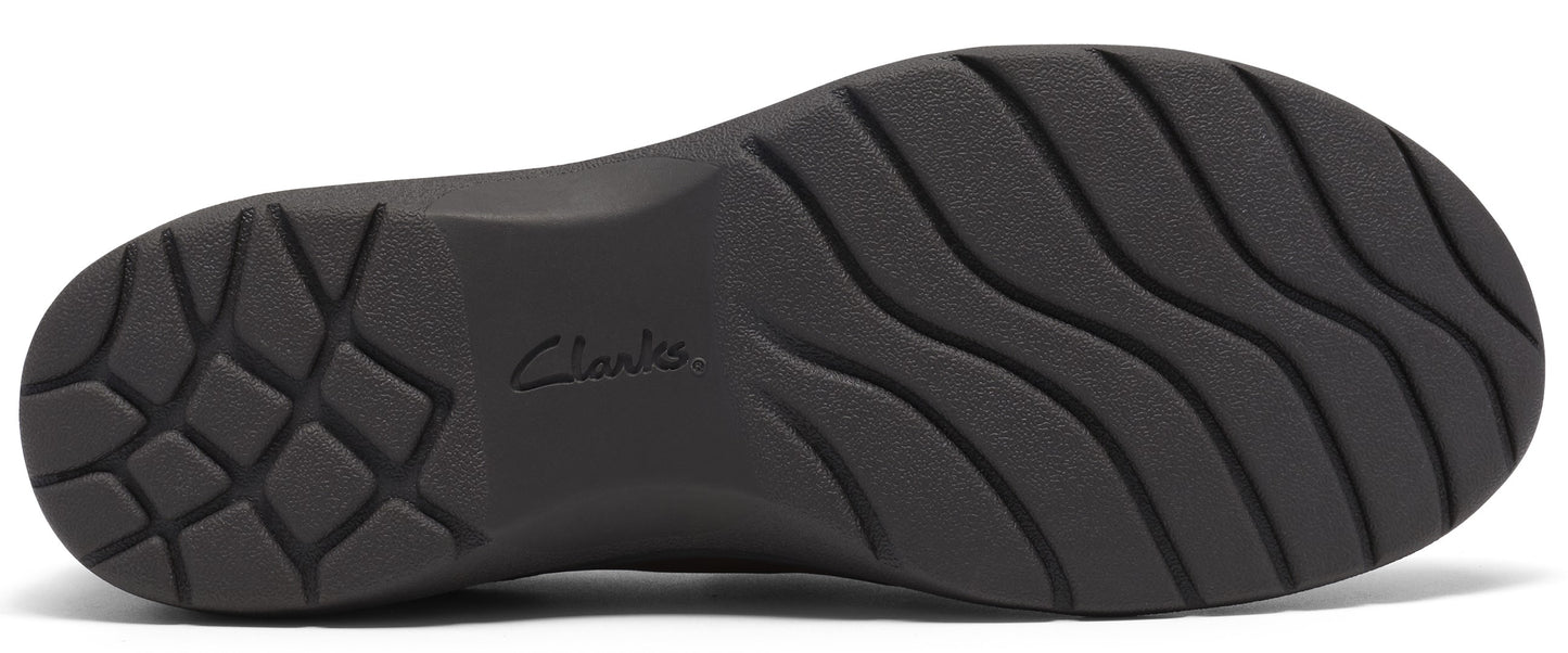 A black, textured shoe sole with a geometric tread pattern at the heel and wavy, horizontal grooves across the rest of the surface, featuring the word Clarks embossed in the center.