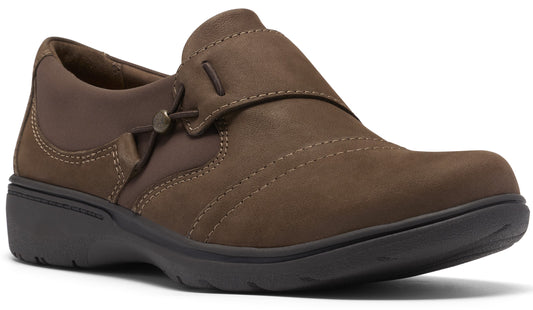 A slip-on shoe in dark brown matte leather, featuring a decorative side toggle and elastic strap detail, complete with a dark grey molded rubber sole.
