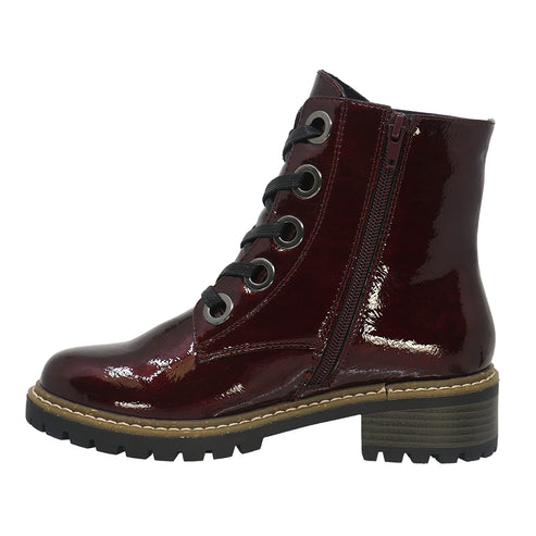 Maroon patent leather ankle boot with laces and side zipper, lug sole and block heel.