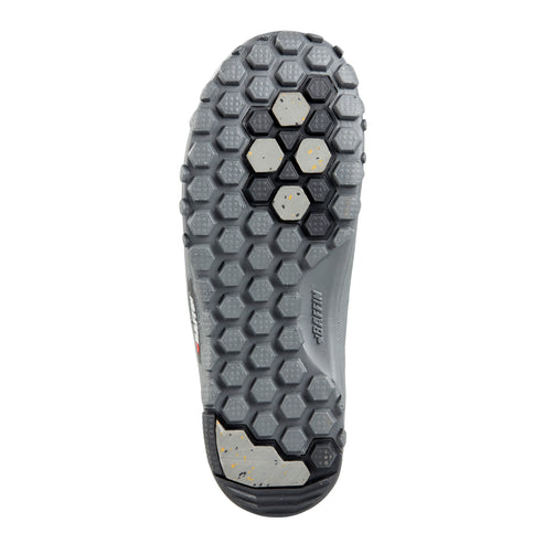 Sole of a gray shoe with a dark gray honeycomb pattern and several silver ice spikes.