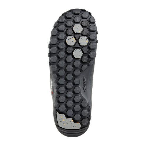 Bottom of a shoe with a black honeycomb pattern and some silver-colored studs.