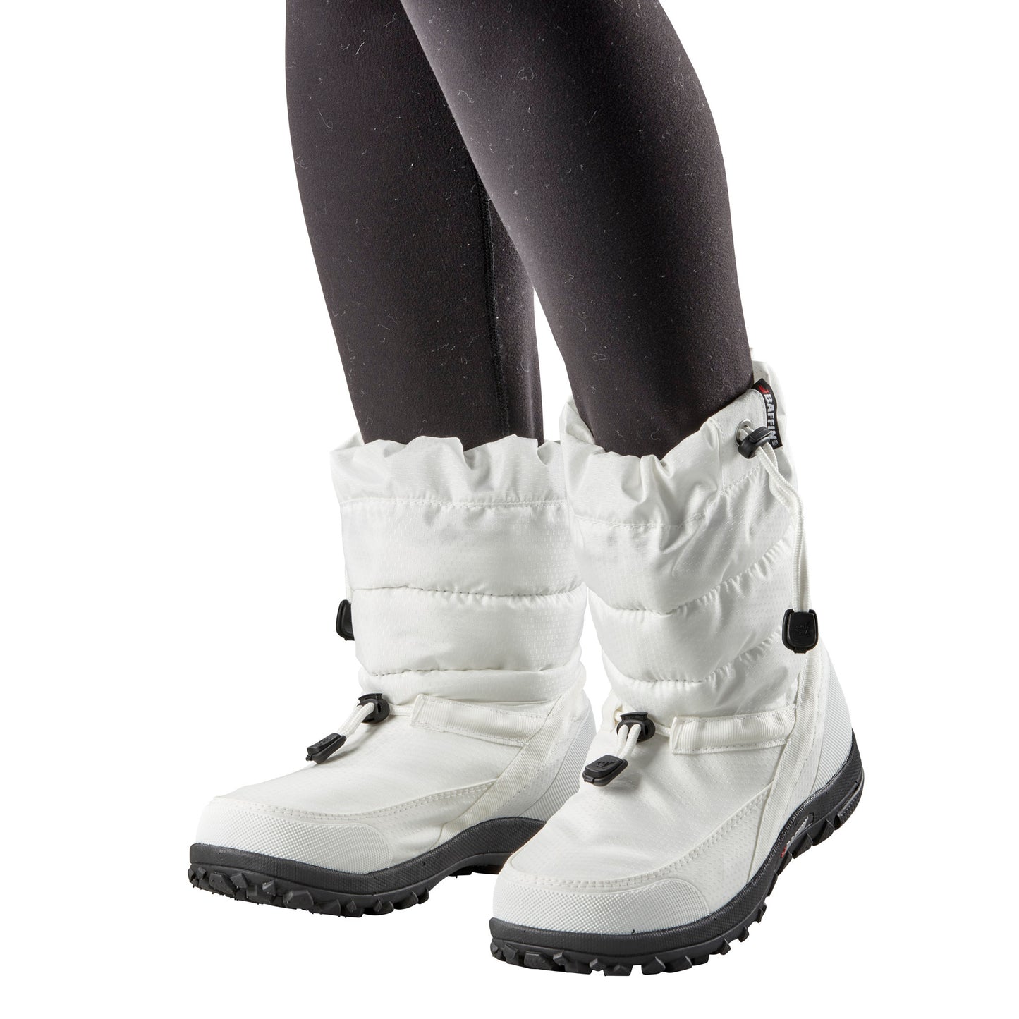 White winter boots with black sole, worn with black leggings.