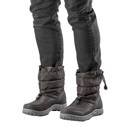 Two gray puffer boots with drawstring closure being worn with black jeans.