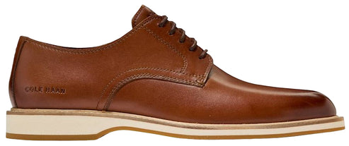 A brown leather Cole Haan dress shoe with a white sole.