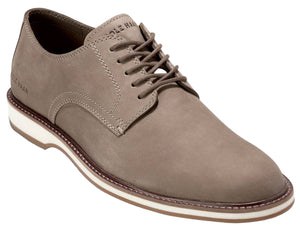 Taupe leather dress shoe with white sole and visible text on the tongue.