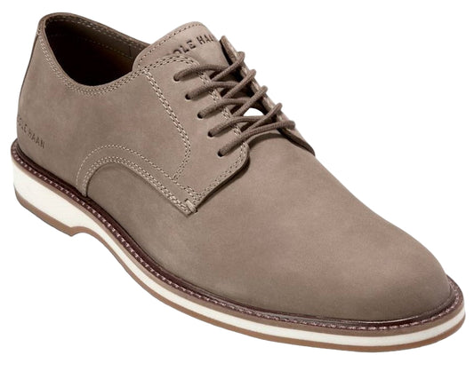 Taupe leather dress shoe with white sole and visible text on the tongue.