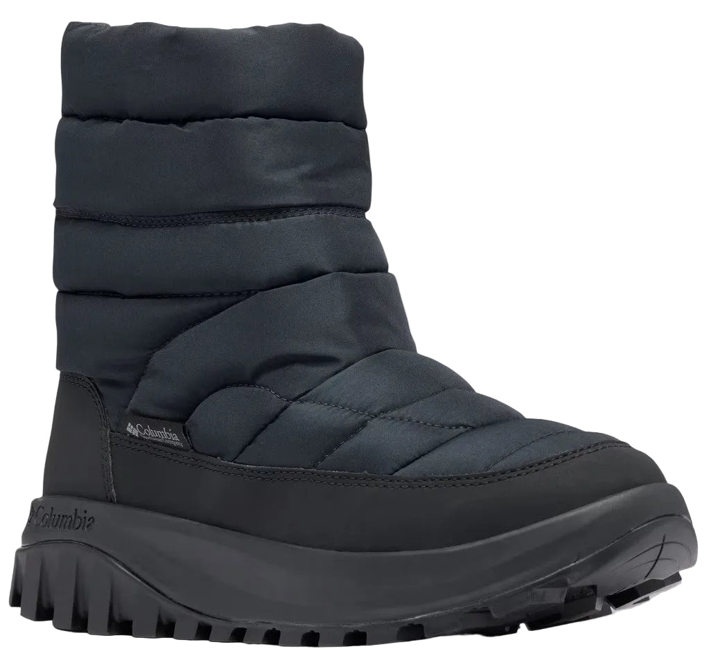 A black insulated slip-on winter boot with a quilted nylon upper, a thick rubber midsole, and a deep-lugged outsole, featuring the brand name Columbia printed on the side of the heel and a small logo tag.