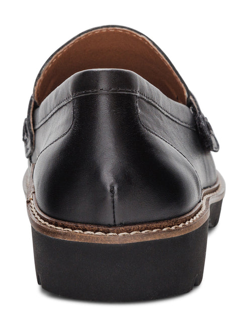 Back view of a black leather loafer with buckle, featuring brown trim and black lug sole.