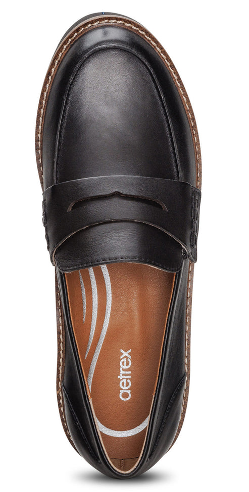 Black leather loafer with a textured brown sole and 'Aetrex' logo on the insole.