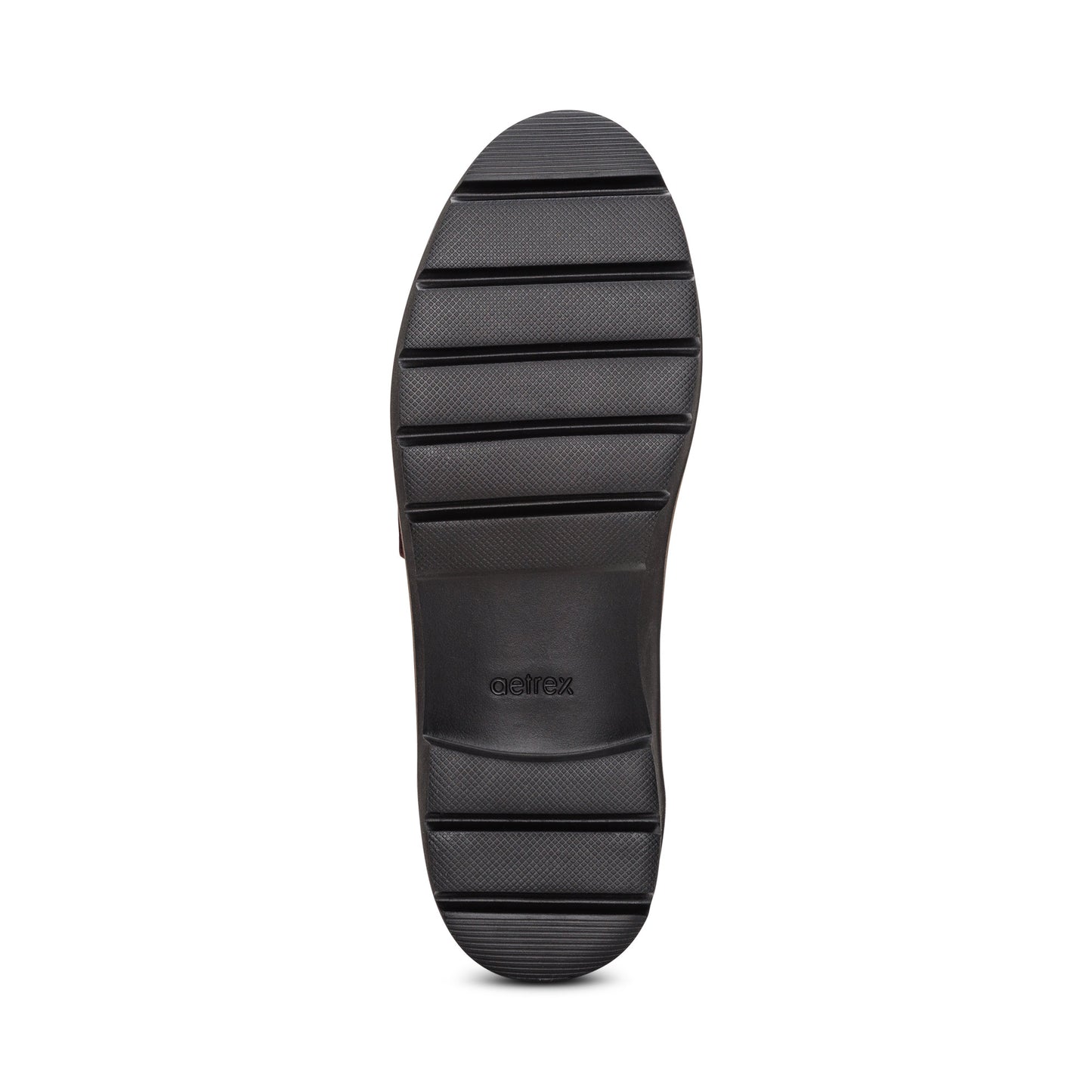 Black lug outsole of a shoe.