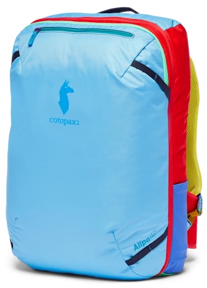 A brightly colored backpack features a light blue front panel with the Cotopaxi llama logo and 'Allpa 42' text printed near the bottom, accented by red side panels, neon green back straps, and a small blue pouch on the side.