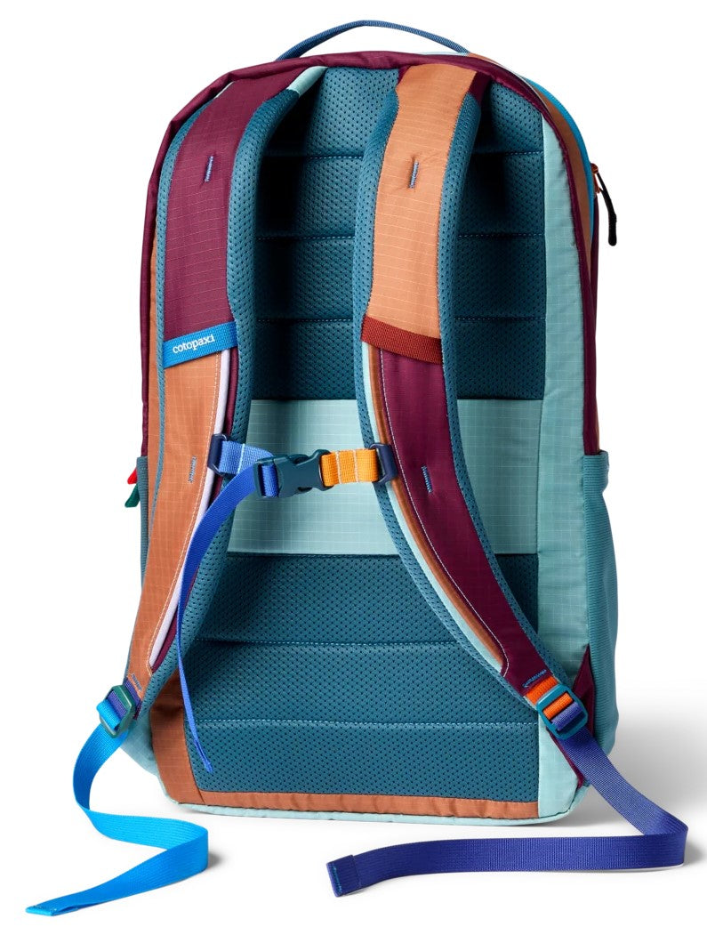 Back view of a multi-colored backpack with a teal mesh back panel, maroon and orange shoulder straps, a blue sternum strap, and teal and purple adjustment straps.