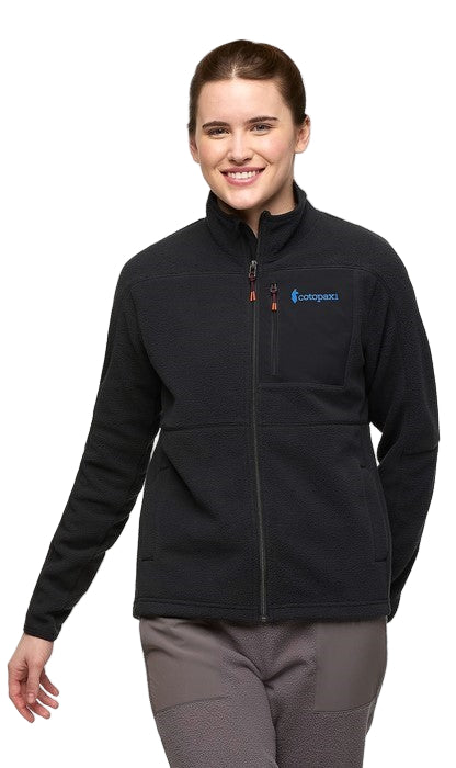 A woman wearing a black zip-up jacket with a blue logo on the right chest.