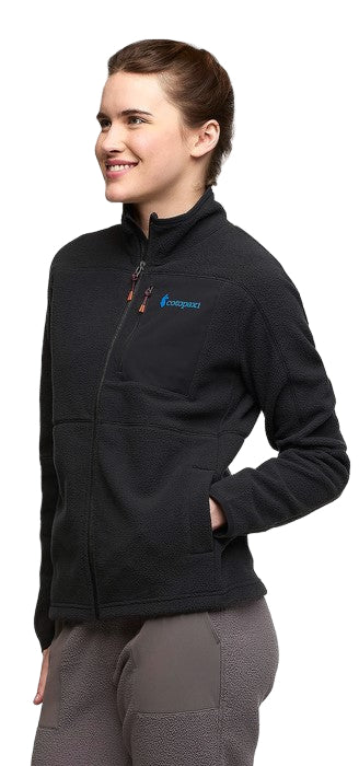 A woman in a black fleece jacket with zipper and pockets.