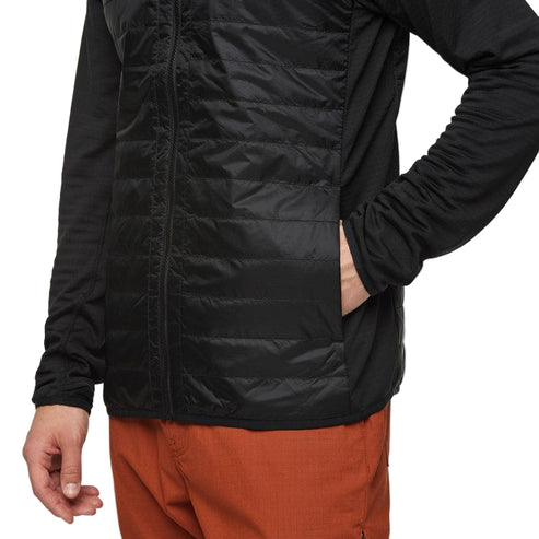 Black quilted jacket with full zipper and side pockets; worn with orange pants.