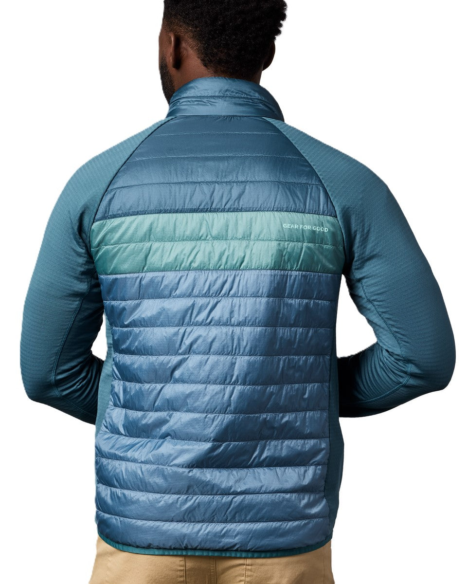 Back view of a quilted blue jacket with blue sleeves.
