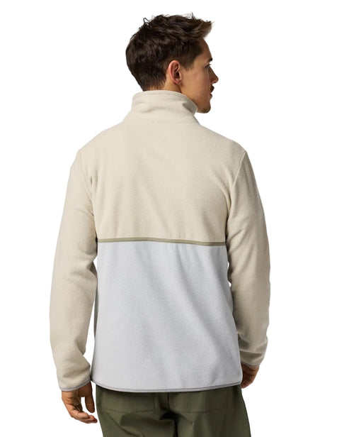 Man wearing a two-tone beige and grey fleece with a stand-up collar.