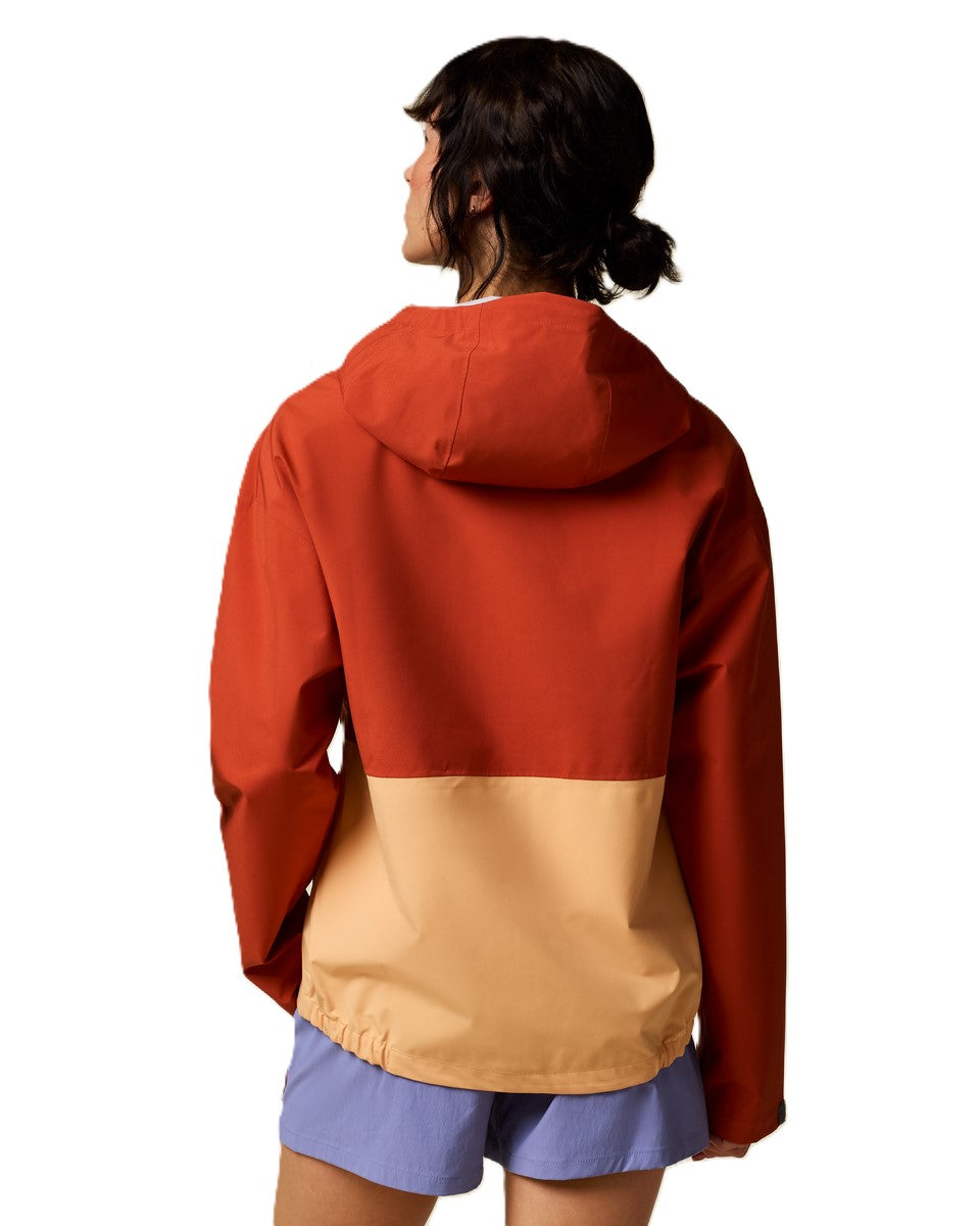 A two-tone hooded jacket featuring a terracotta top and tan bottom with blue shorts.